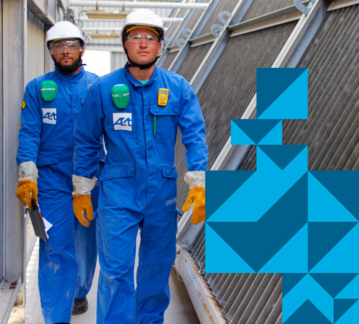 Two trainers wearing PPE safely moving on-site