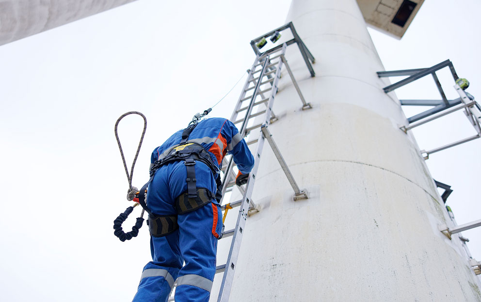 Safety drill under real-world conditions involving climbing the ladder of a training wind turbine