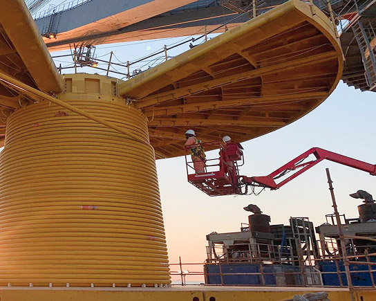 Umbilical re-spooling operation during an offshore intervention on an industrial facility 