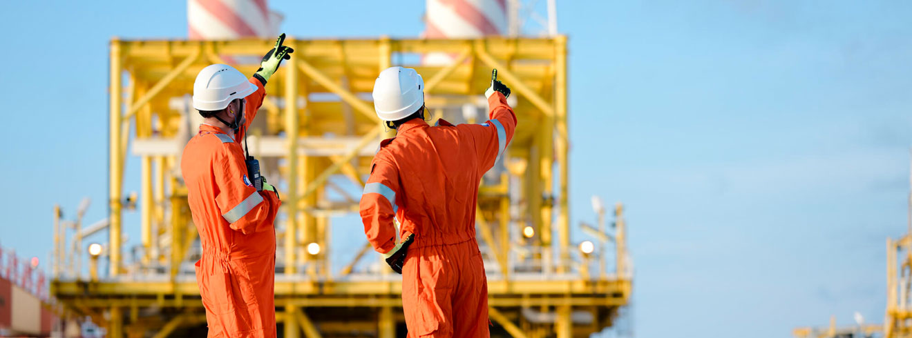 Technicians in safety gear coordinating an operation on an industrial site